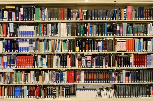 A shelf full of booksDescription automatically generated